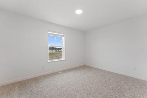 (Photo of a similar home, actual finishes may vary) All bedrooms in the home include plush wall-to-wall carpeting and practical wardrobe closets