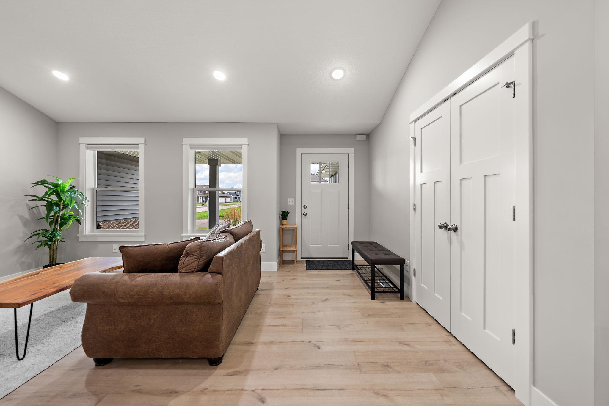 The main entrance of the home enters into the living room with street view through the living room windows. Coat closets are on the right.