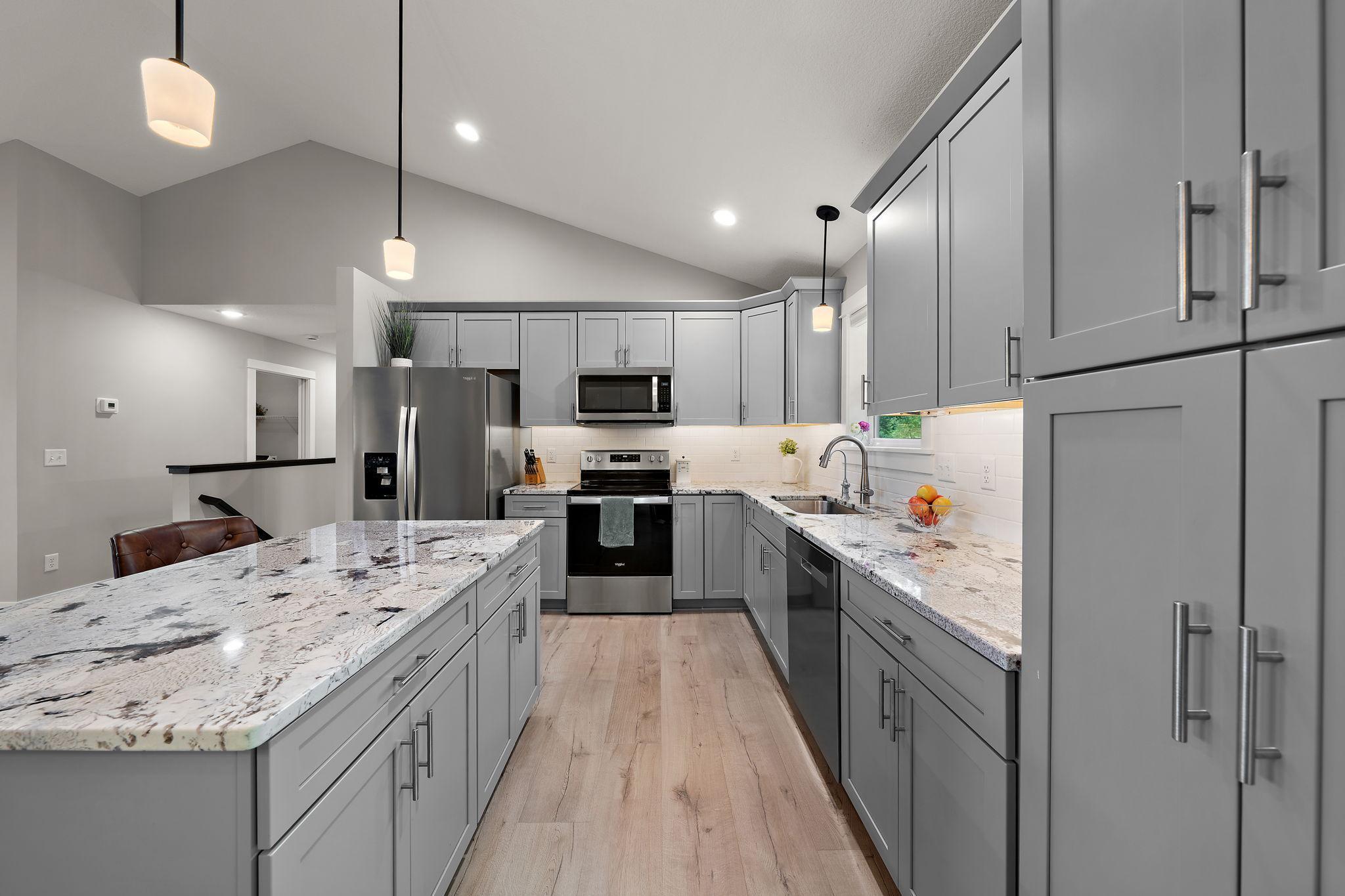 The island counter has additional storage drawers and cabinets.