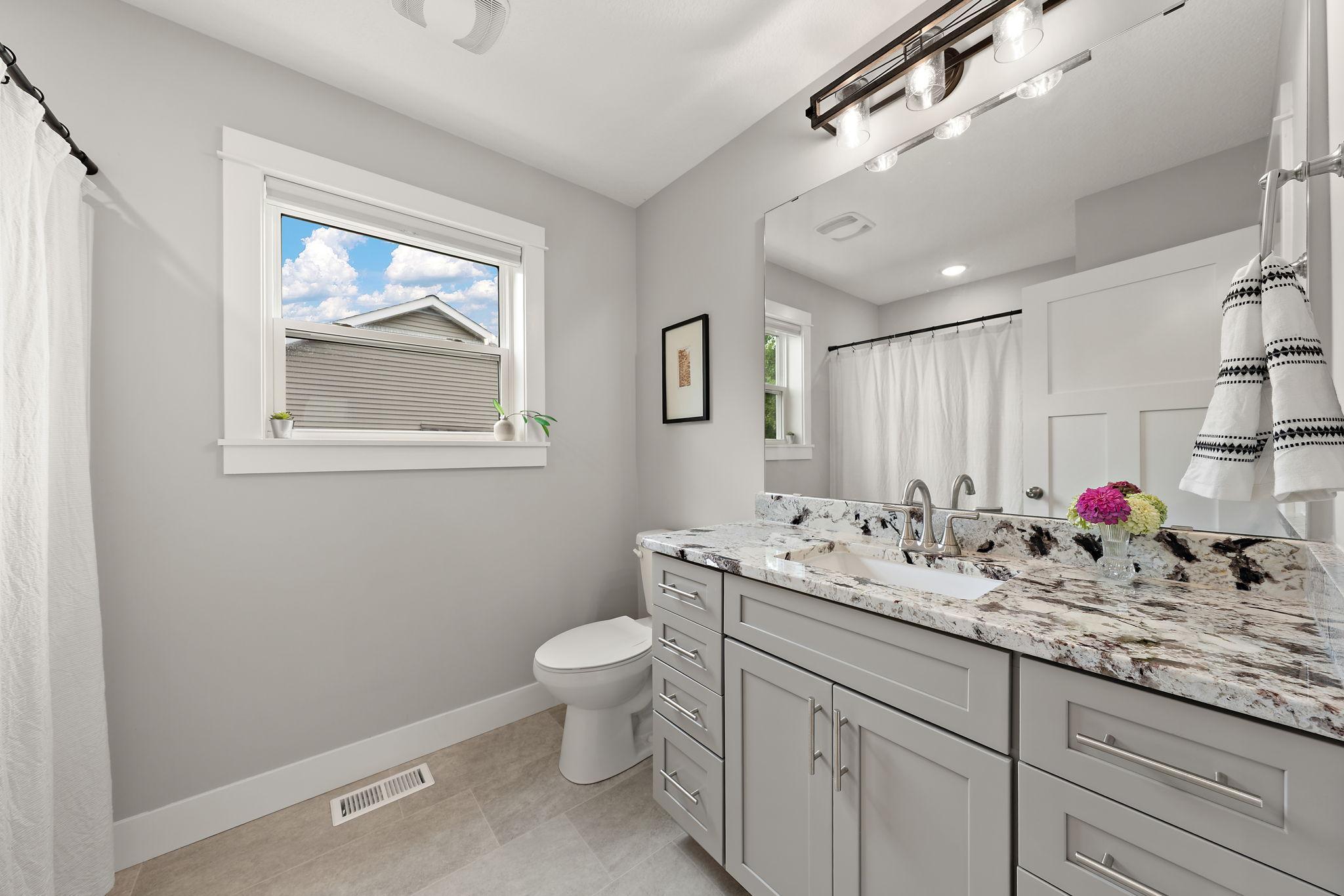 The main floor full bathroom located right off the hallway and living room.