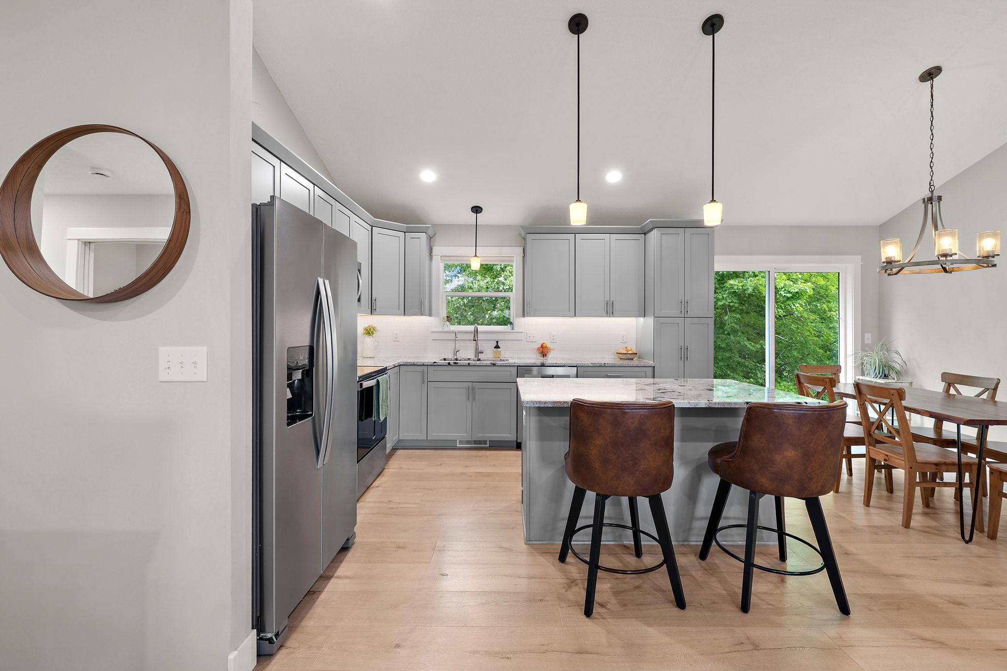 The kitchen has plenty of storage and offers a breakfast counter which can also serve as a buffet serving area when hosting guests.