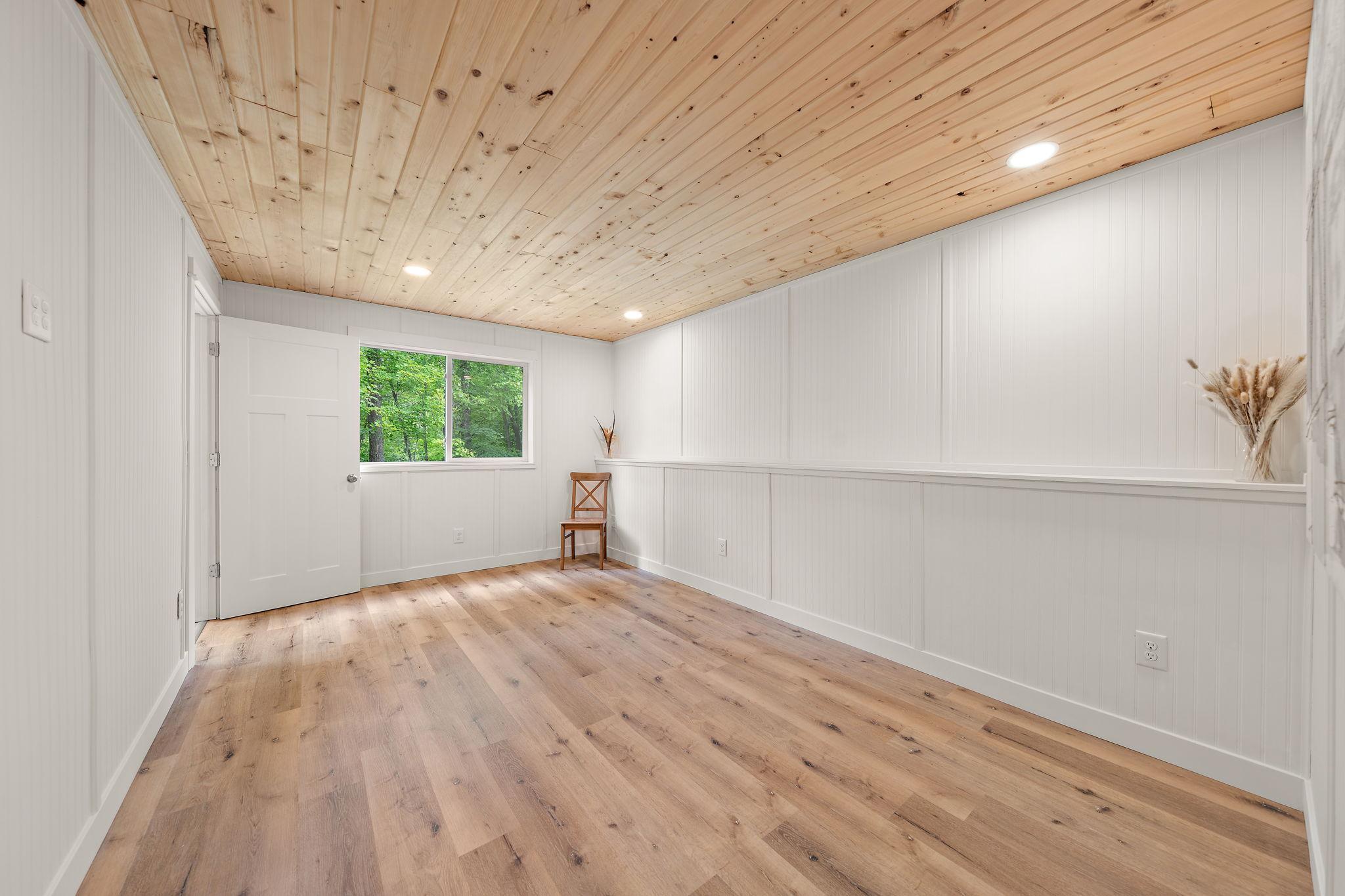 The fifth bedroom is right off of the family room with the walkout patio door immediately accessible through the bedroom door on the left.