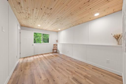 The fifth bedroom is right off of the family room with the walkout patio door immediately accessible through the bedroom door on the left.
