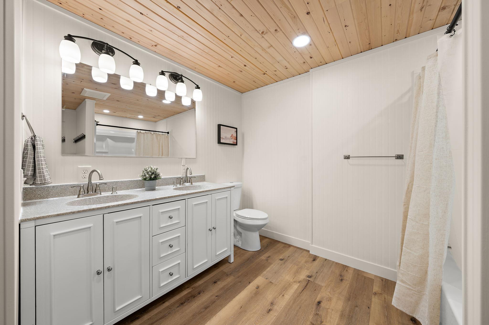 The lower level full bathroom has ample storage space under the sink.