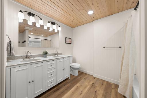 The lower level full bathroom has ample storage space under the sink.