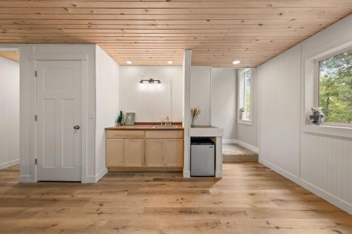 The basement level has a wetbar and a storage closet with hallway to the utility room and fourth bedroom on the far left.