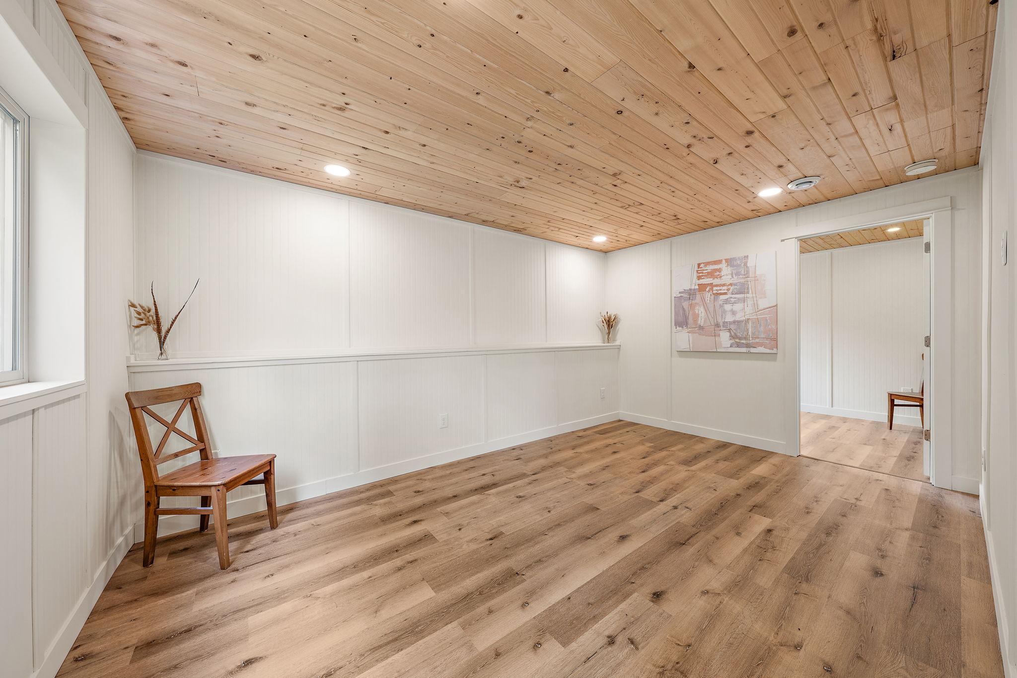 The fifth bedroom on the lower level has a closet/storage space in the room beyond.