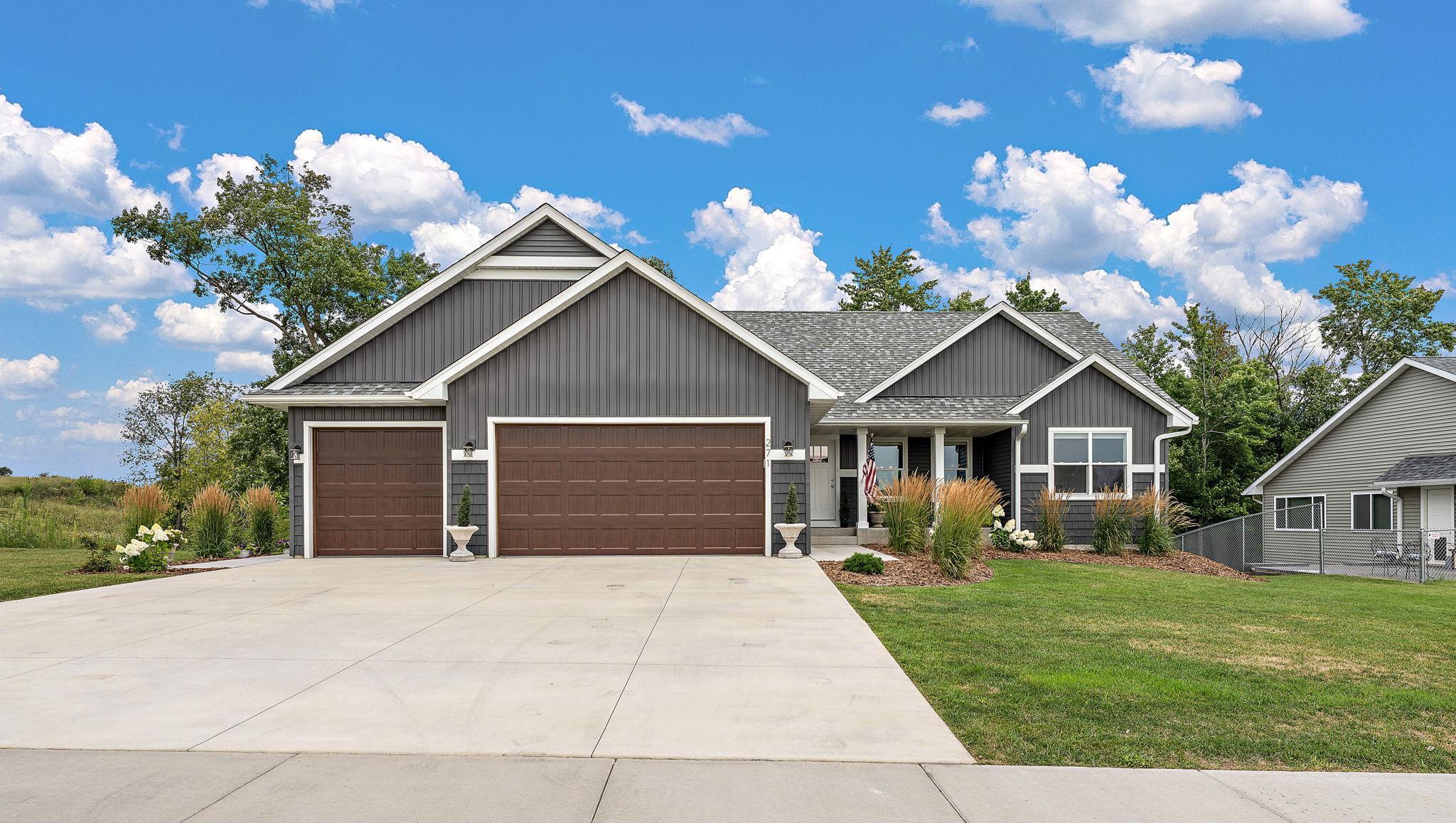 The home features a three car heated and insulated garage and a lovely curb view with a wooded area in the back of the lot. The front yard was sodded and landscaping was completed in 2025. The garage doors have a wood look and are insulated.