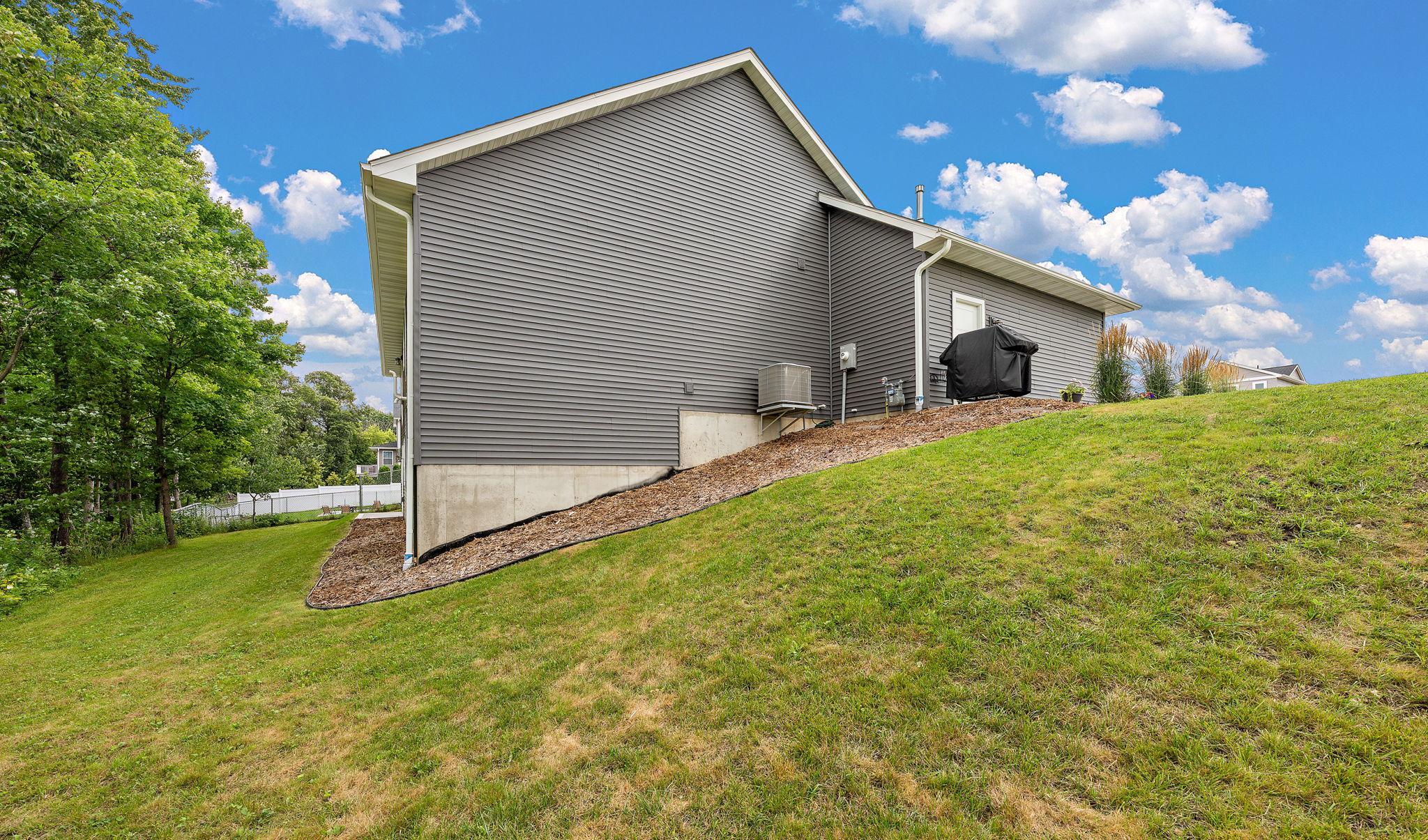 The home has a sizeable lawn for gardening or yard games.