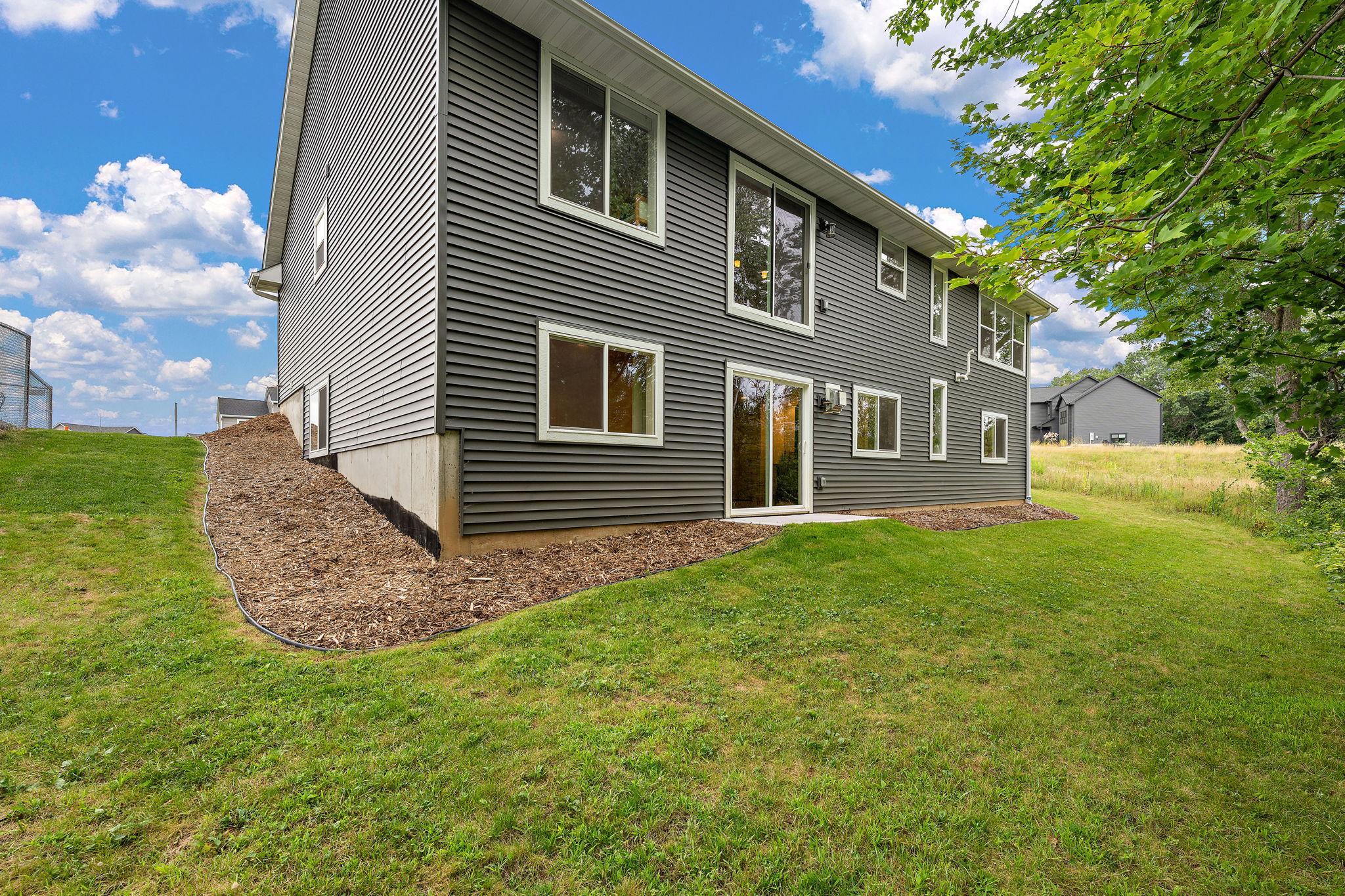 The back of the home features a cement walkout from the basement.