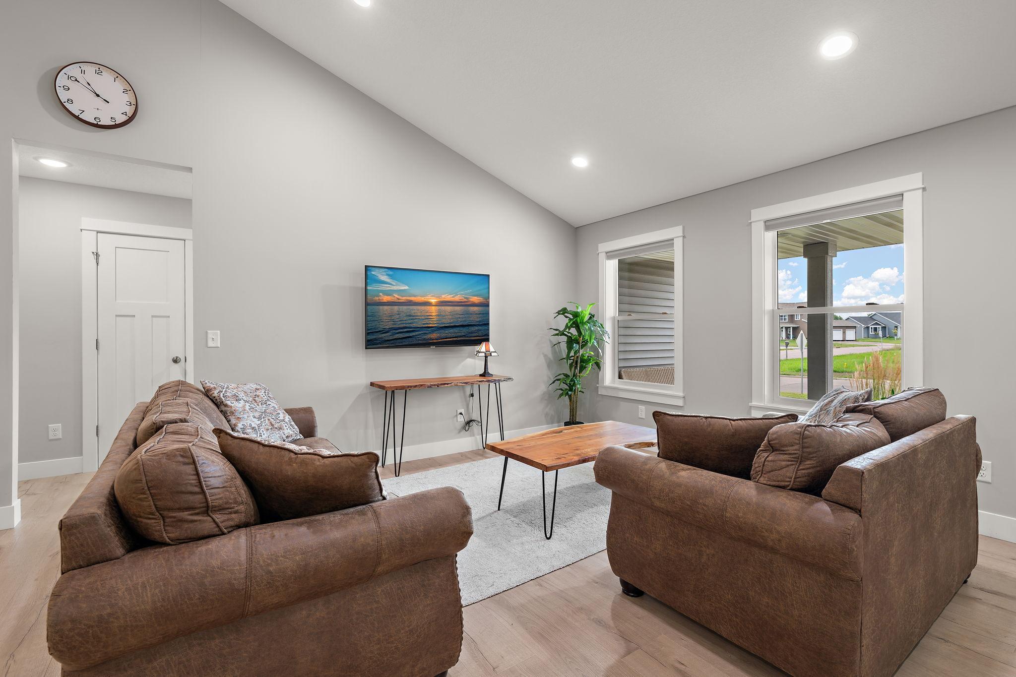 The living room has high ceilings and large windows to allow plenty of natural light into the space.