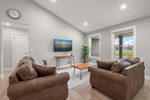The living room has high ceilings and large windows to allow plenty of natural light into the space.