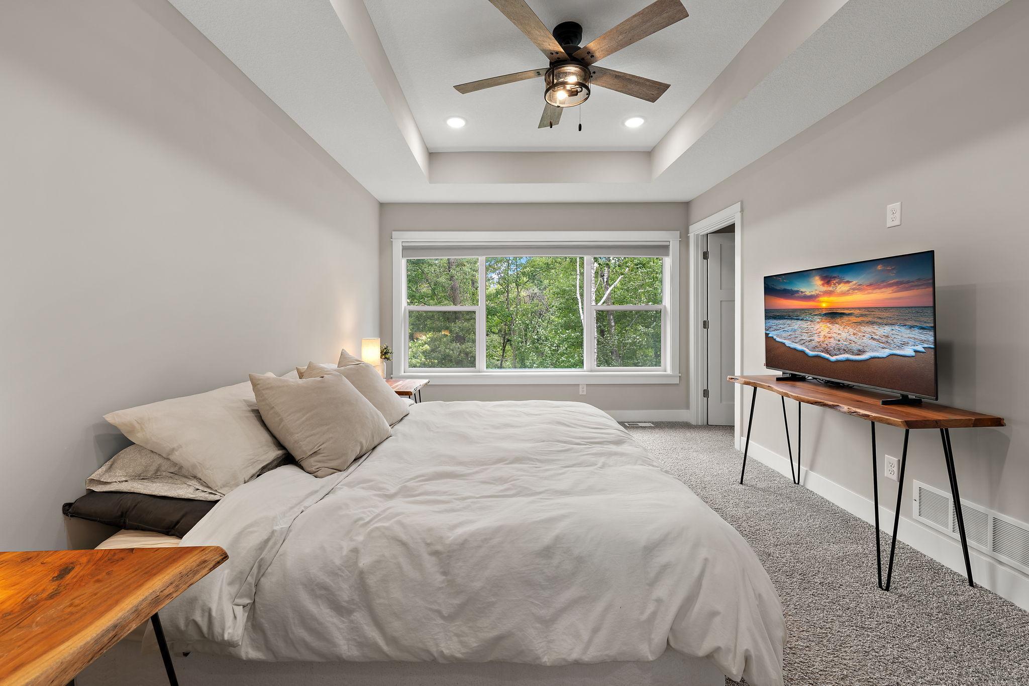 The primary bedroom also has walk-in-closets which are to the right through the open door beyond.