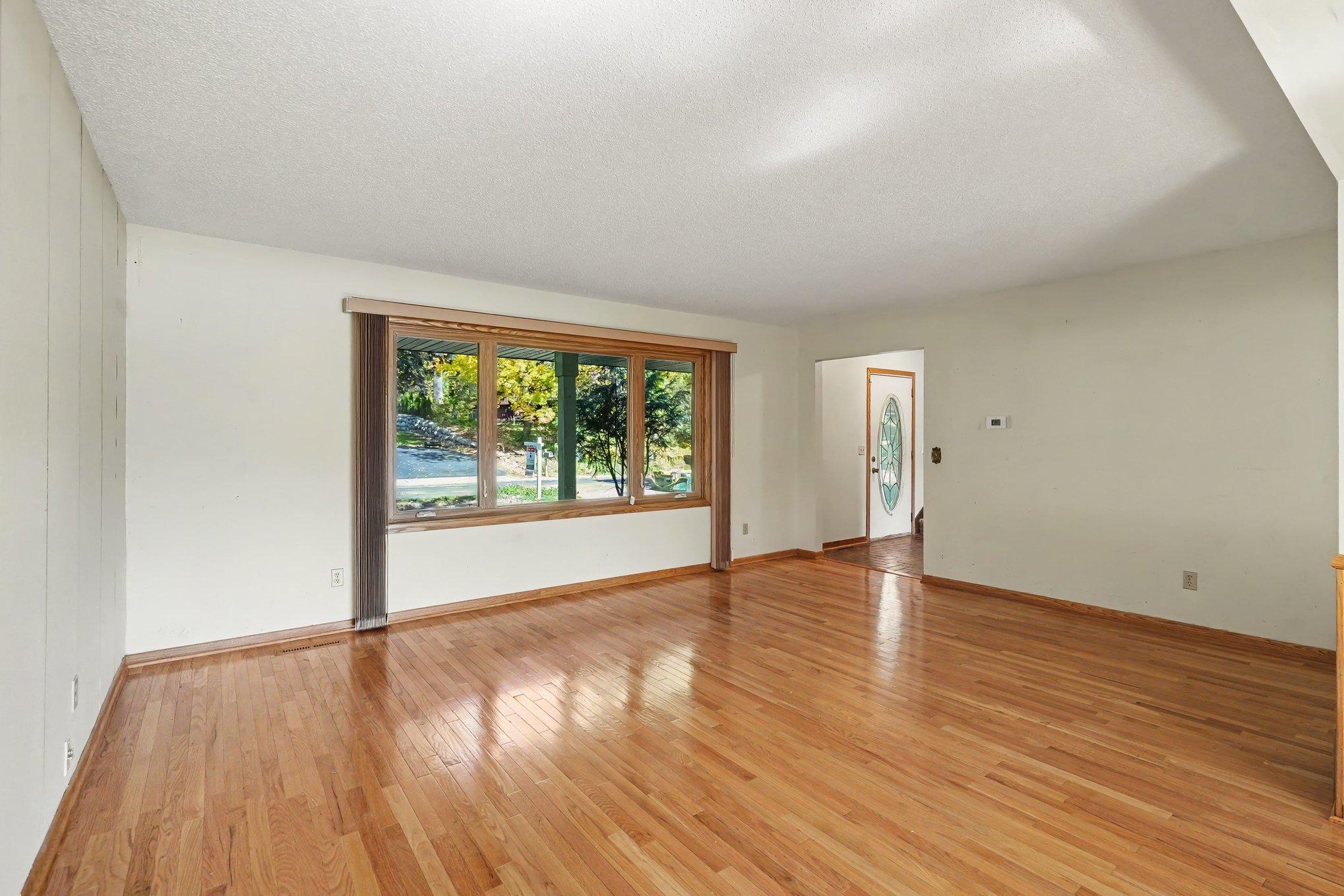 Large ceramic entry flows to living room with sun filled picture window.