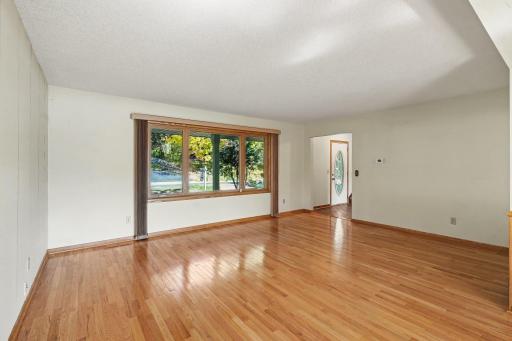Large ceramic entry flows to living room with sun filled picture window.