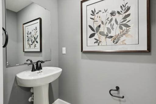 (Photo of a decorated model, actual homes finishes will vary) Conveniently located powder bath on the main level.