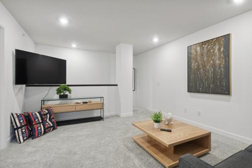 (Photo of a decorated model, actual homes finishes will vary) Located on the upper level, this perfectly sized living space has enough room for a desk, television and seating for all. Plus, it is just steps away from the three bedrooms.