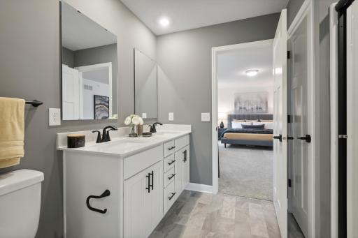 (Photo of a decorated model, actual homes finishes will vary) An extension of the owner's suite, this private and spacious bath contains a double-vanity, a linen closet and a shower.