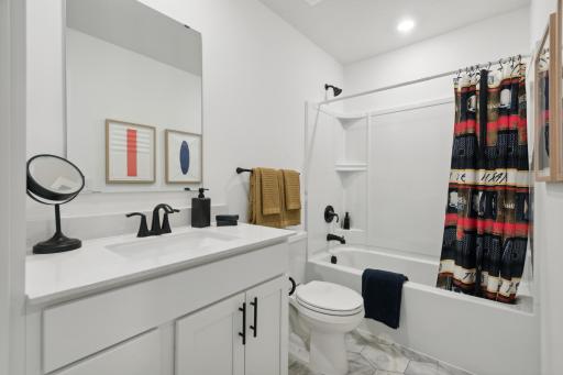 (Photo of a decorated model, actual homes finishes will vary) The upper level secondary bath is sure to provide plenty of space for everyone to get ready in the morning.
