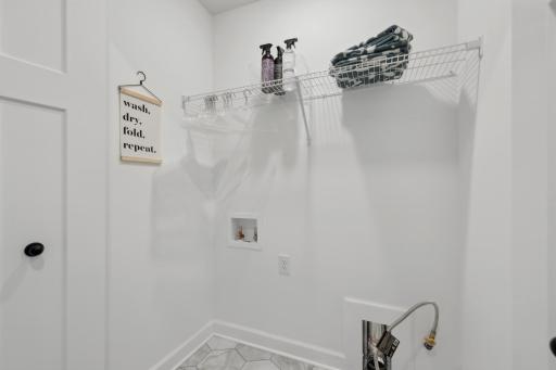 (Photo of a decorated model, actual homes finishes will vary) Centrally located on the upper level, along with the three bedrooms, this laundry room is sure to provide the ultimate convenience.