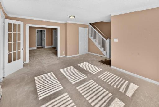 On the other side the living room opens to the dining area and kitchen.