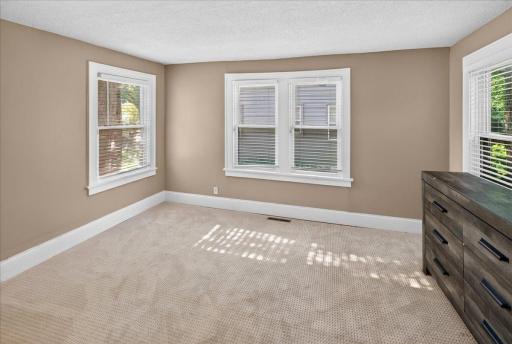 Main floor bedroom overlooking side yard and backyard.