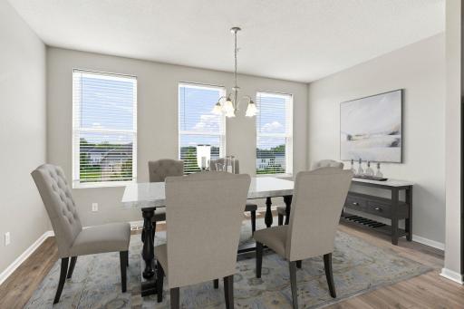 5140 Hampton St NE - The stunning dining area is a wall of windows, with space for everyone around the table. Virtually staged