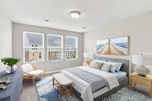 5140 Hampton St NE - This roomy primary suite includes a sizeable walk-in closet, as well as a 3/4 bath with double sinks and a separate toilet area. Virtually staged