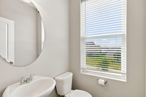 5140 Hampton St NE - This convenient powder room is tucked away in the corner of the main level, convenient yet separate