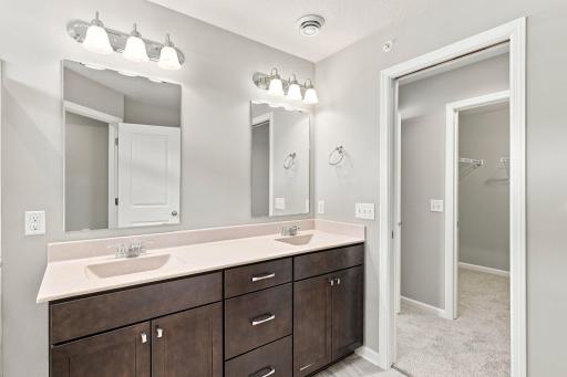 5140 Hampton St NE - Primary bath features a solid surface vanity, double sinks and double mirrors