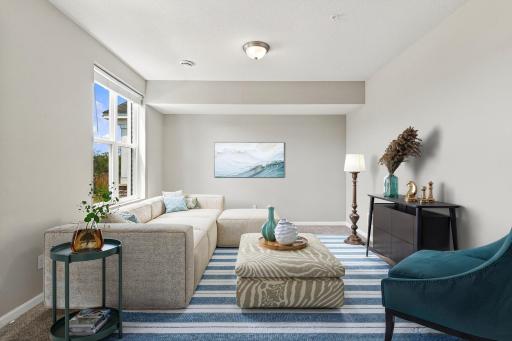 5140 Hampton St NE - Entry level family room could also be used as an office/playroom, or game area. Virtually staged
