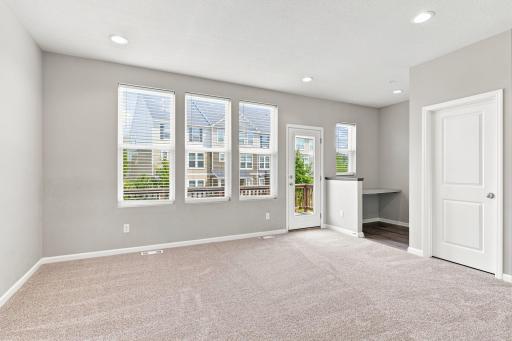 5140 Hampton St NE - view from the edge of the kitchen to the living room, balcony, behind the door a huge pantry, and in between is a handy desk/office space