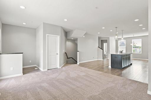 5140 Hampton St NE - view from living room - balcony is to the left, desk/office/flex space is in the back left, large pantry/closet is behind the door