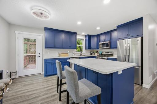 Bright inviting kitchen featuring ample cabinetry, counterspace and an open layout.