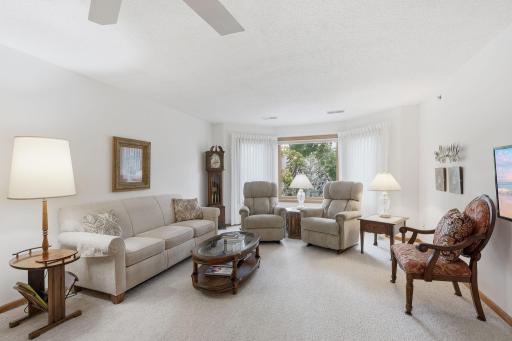 The living room features a bay window to bring in natural light.