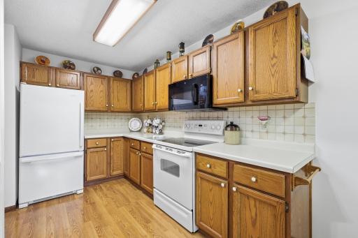 The kitchen has plenty of cabinets and counter space.