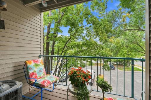 Balcony easily accommodates two chairs and a small table.