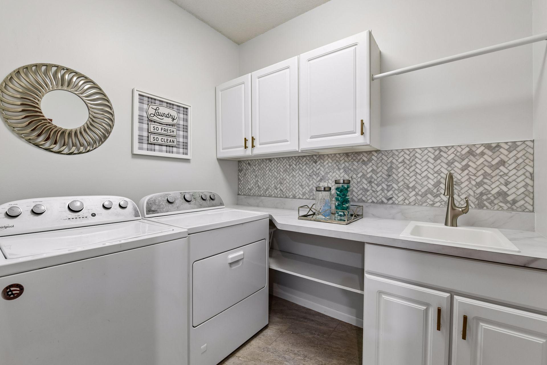 An adjacent laundry room adds to the convenience of main-level living.