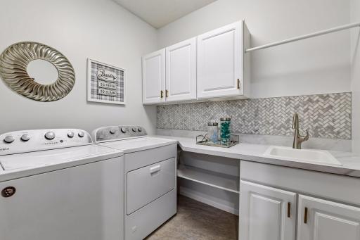 An adjacent laundry room adds to the convenience of main-level living.