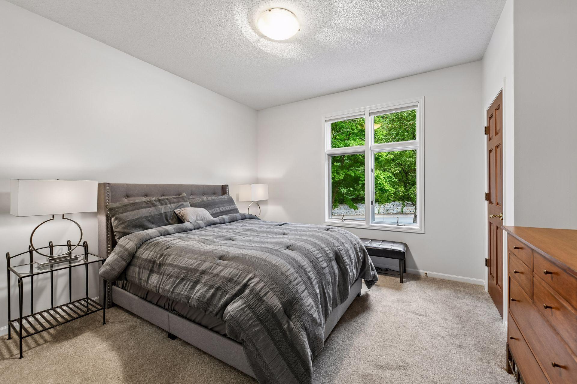 A second main-level bedroom, which also works beautifully as a den or office, and a three-quarter bath provide additional flexibility for family and guests.