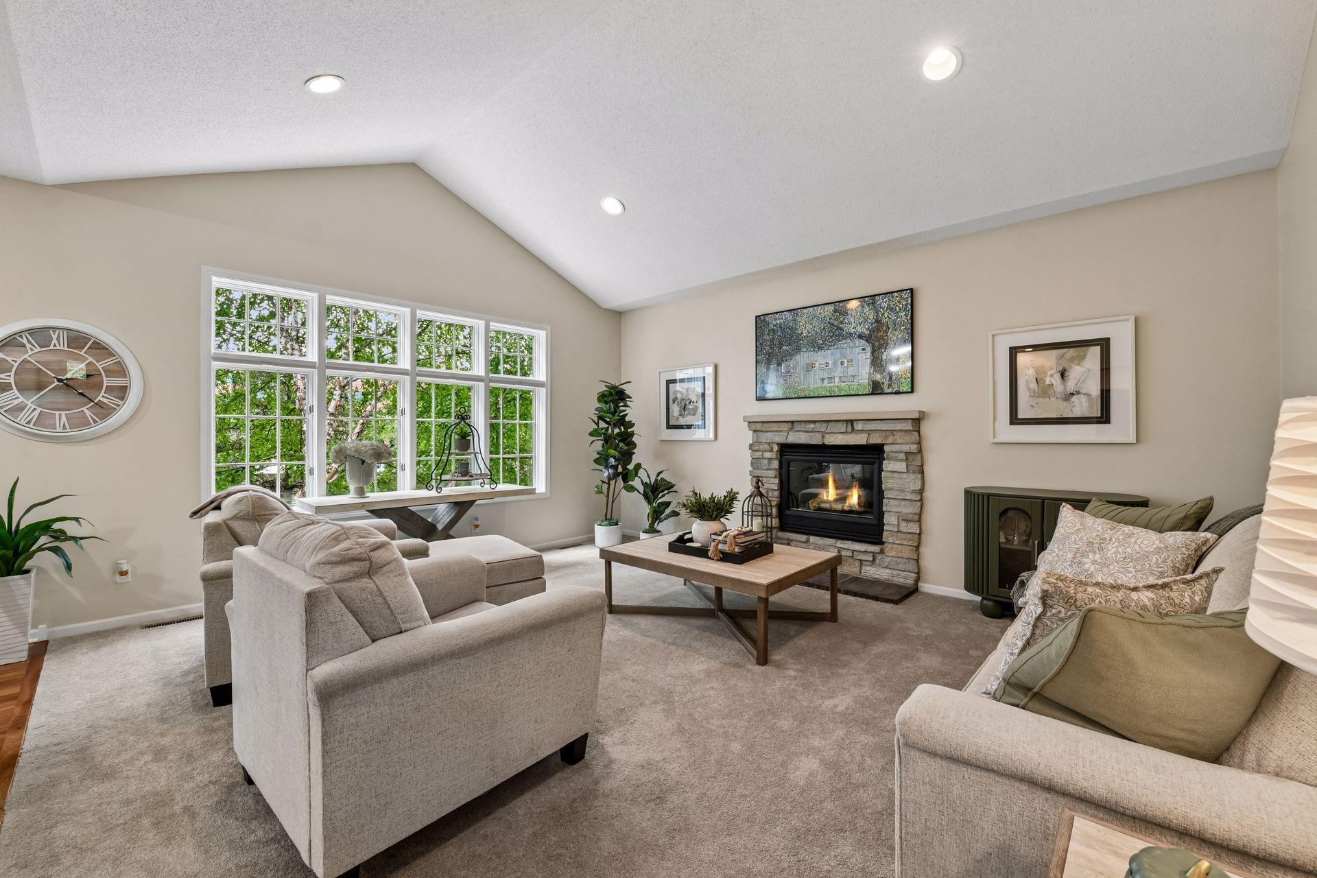 Gorgeous hardwood floors welcome you inside and lead past the formal dining room to the impressive vaulted living room, anchored by a beautiful stone-surround gas fireplace.
