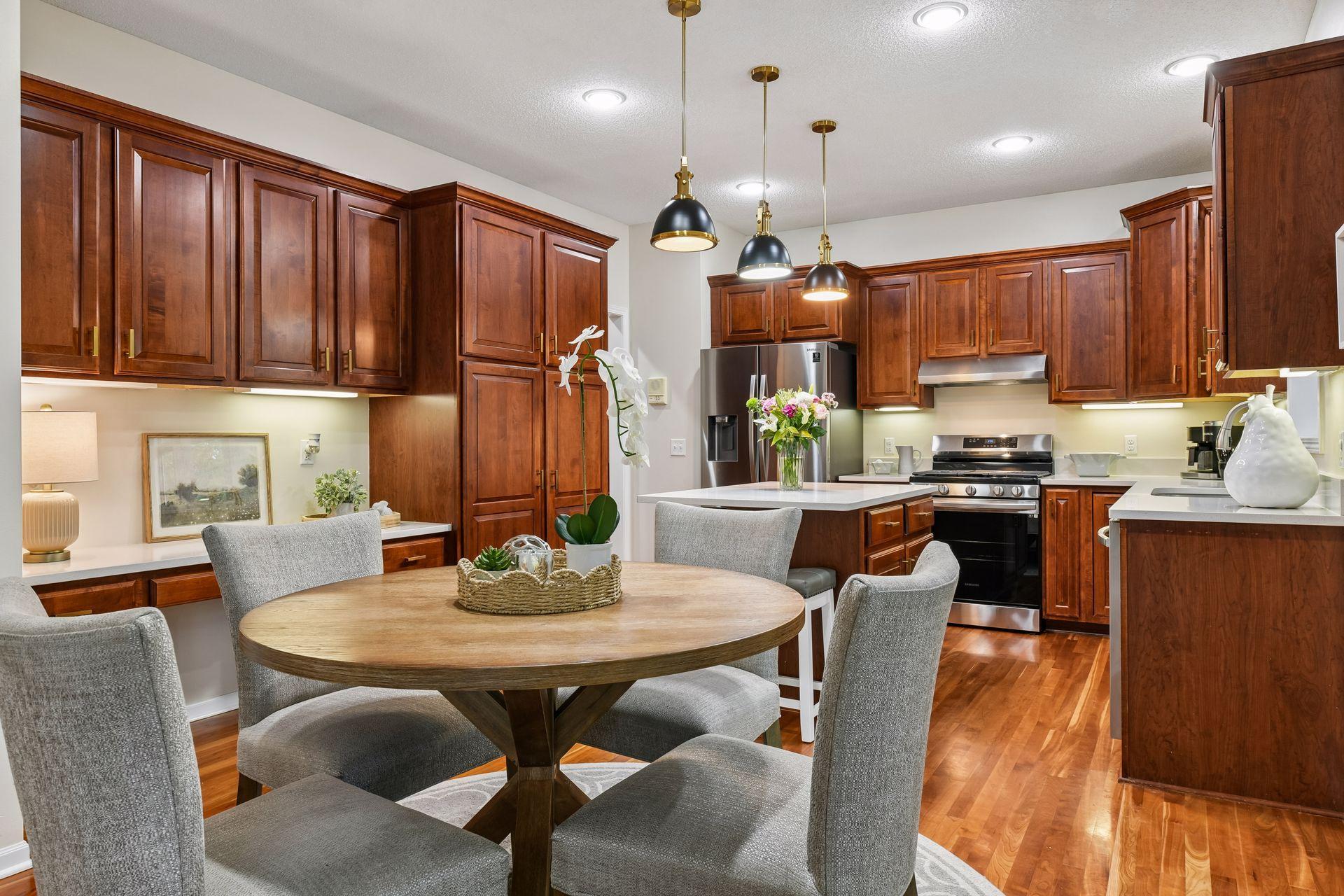 The gourmet kitchen features custom cabinetry, quartz countertops, a center island and a convenient butler’s pantry, creating an ideal setting for both entertaining and everyday living.