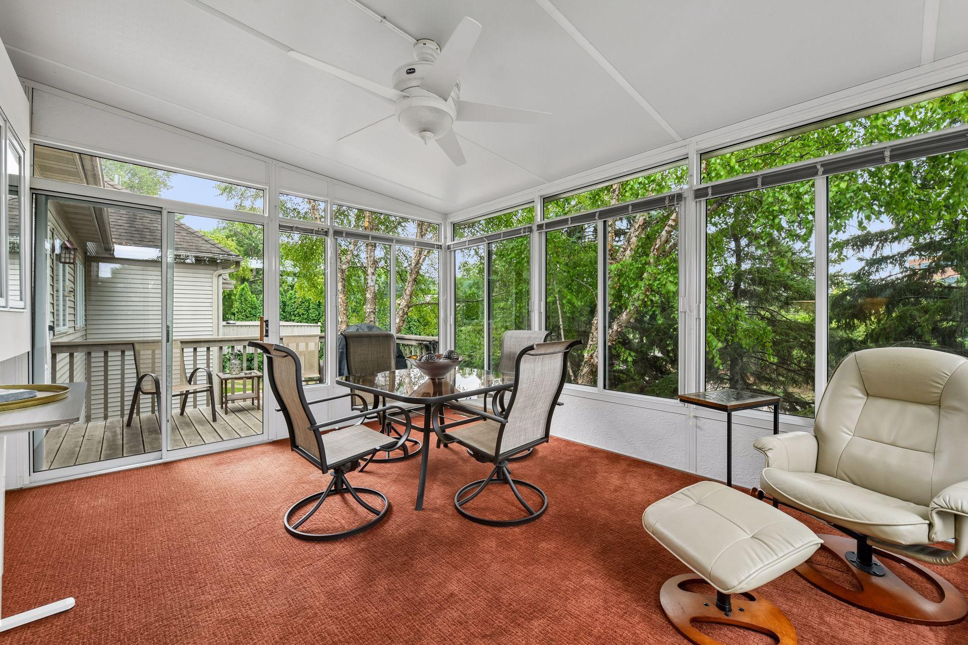 One of the home’s most special features is the raised three-season porch, a peaceful retreat overlooking mature trees and frequent wildlife. With windows and screens, it offers a wonderful place to relax and enjoy the natural surroundings throughout.