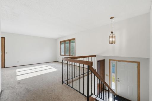 A warm welcome home! The spacious living area sits just off the entry, creating an inviting place to kick off your shoes, get comfortable, and reconnect at the end of the day.