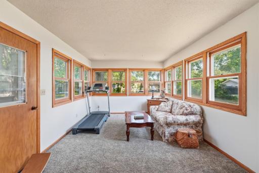 Sunroom extends your living space year-round and features a cozy freestanding gas fireplace, creating the perfect spot to relax with your morning coffee or unwind at the end of the day