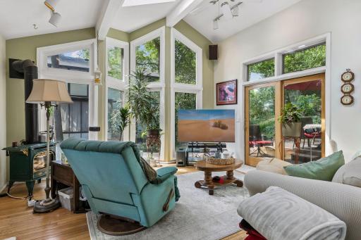 Sunroom with expansive windows, cozy seating, and access to your private oasis.