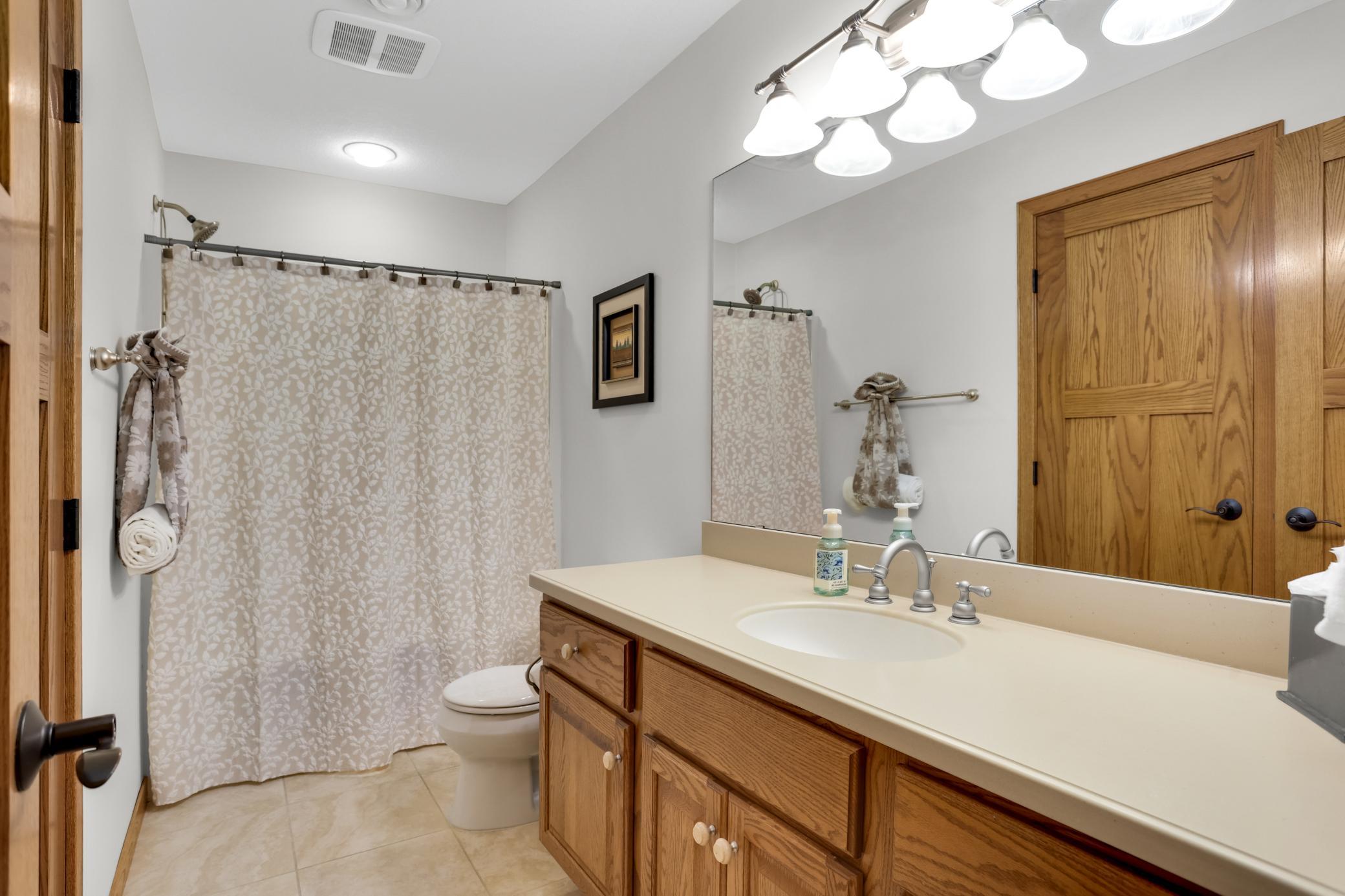 Lower-level full bathroom featuring elegant Cambria countertops and quality finishes.