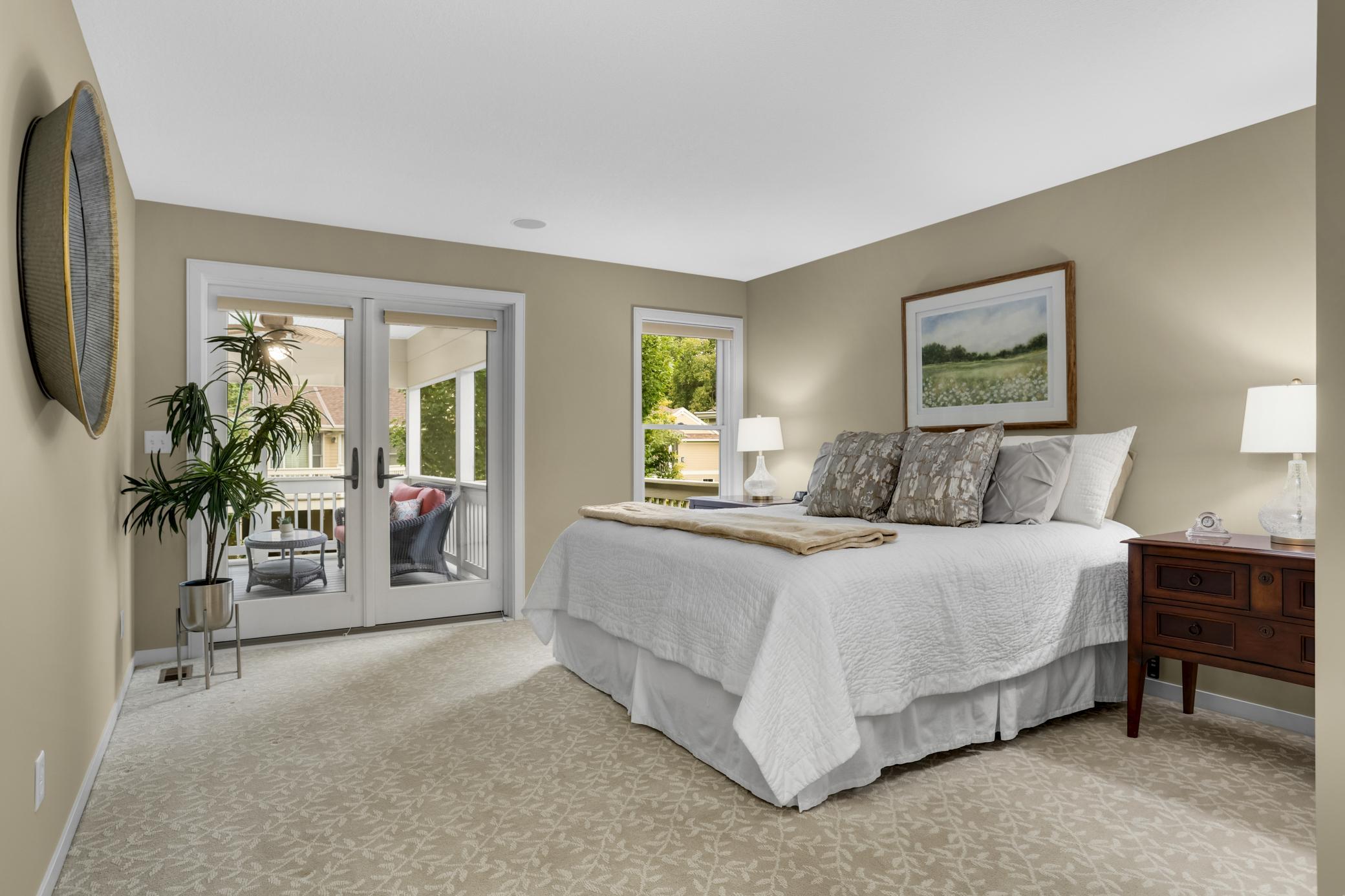 Owner’s suite with direct access to the inviting screened-in porch—perfect for enjoying the peaceful outdoors