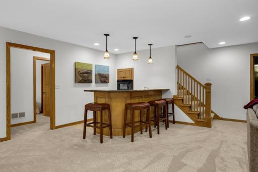 Why not bring the party to the lower level? A convenient pull-up kitchenette features a refrigerator, dishwasher, and microwaveâperfect for entertaining.