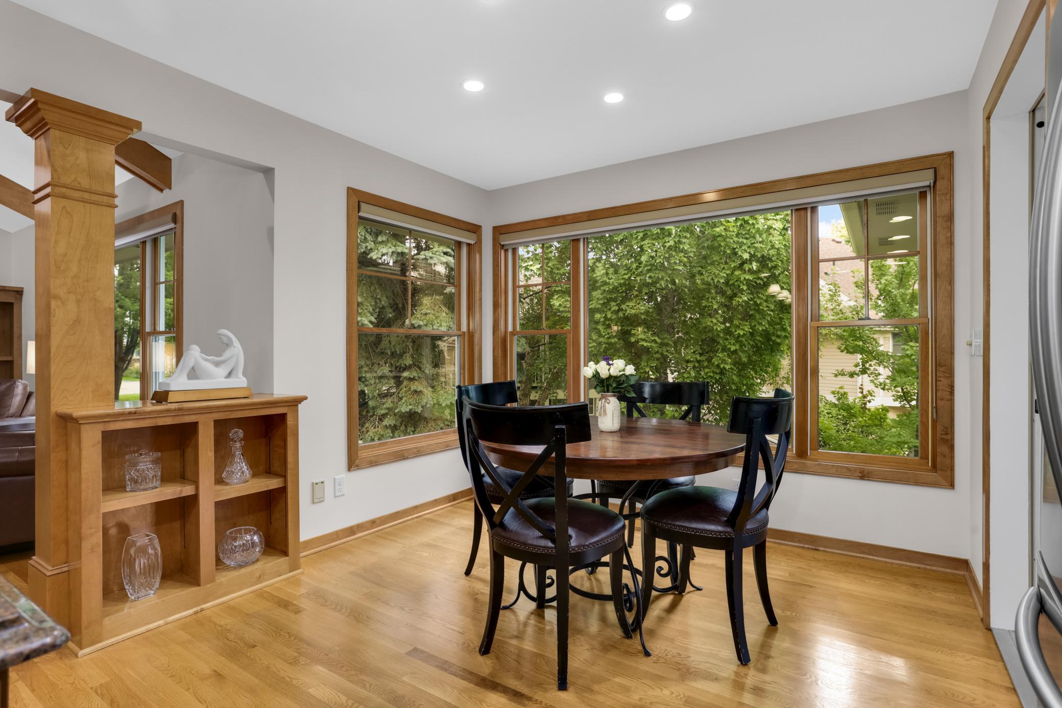 Spacious eat-in kitchen area with beautiful views through the large Andersen windows, creating a bright and inviting space to enjoy every meal.